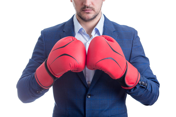 Close up businessman in suit with boxing gloves stands ready in a fighting stance, punching his fists. Business person self defence concept. - Photo, Image