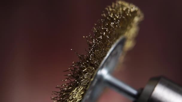 Using a brass wire brush with a drill on a wooden background. Macro. Slow motion - Materiał filmowy, wideo