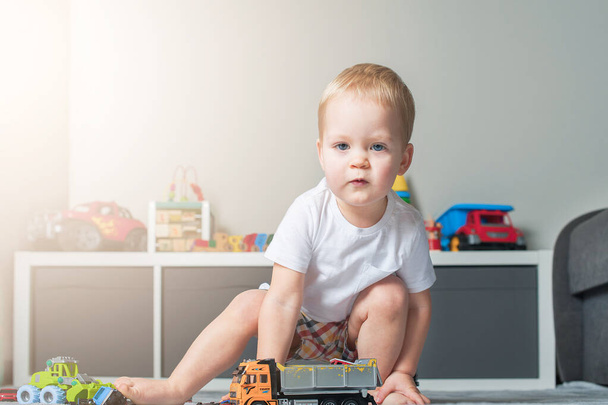 Toddler boy plays in playroom with educational toys... - Photo, image