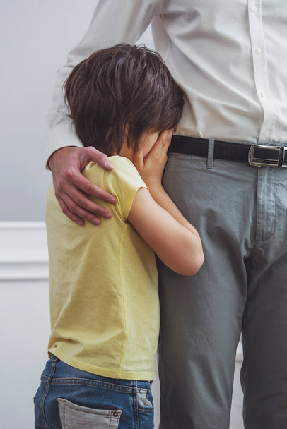 A cute little boy crying while his father hugging him, cropped - Foto, Imagem
