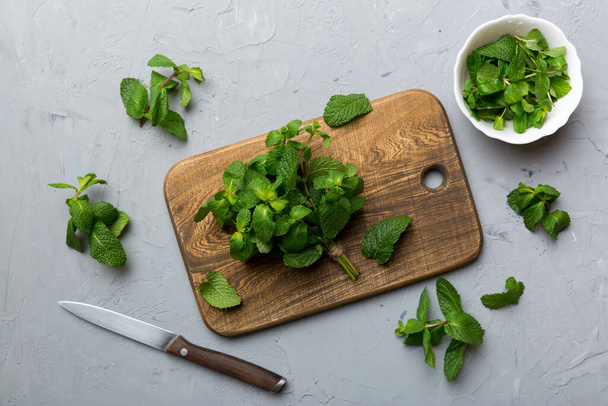 Fresh mint on Cutting board table, top view. Flat lay Space for text. - Photo, Image