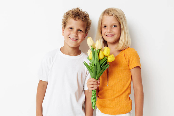 Portrait of cute children holiday friendship with a gift Yellow flowers lifestyle unaltered - Фото, зображення