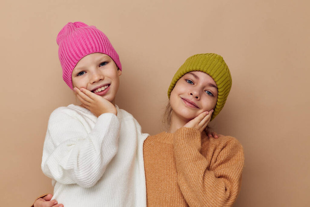 smiling little girls in hats studio childhood - Фото, изображение