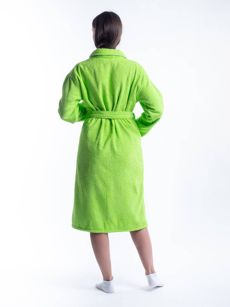 woman in a dressing gown from the back on an isolated white background. Shot in the Studio in full growth. - Fotó, kép