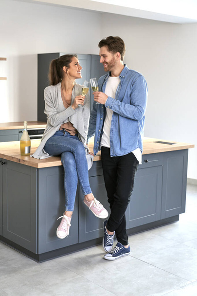 Couple celebrating house ownership with a champagne - Zdjęcie, obraz