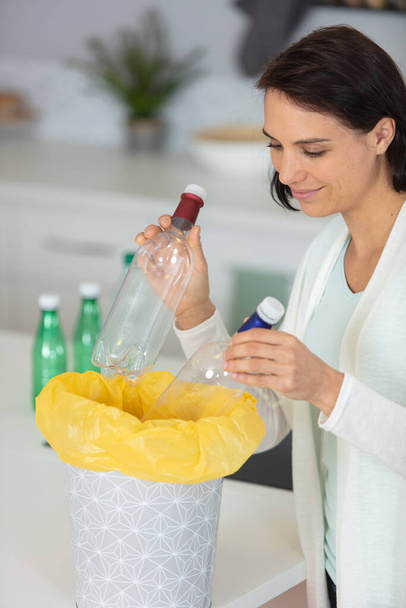 woman recycling plastic water bottles - Foto, imagen