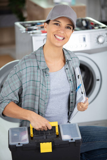 female service agent arrives to fix washing machine - Photo, image