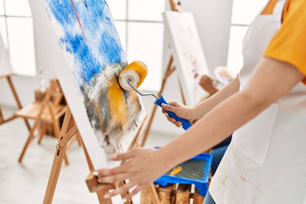 Woman paint student painting using roller at art studio. - Foto, imagen