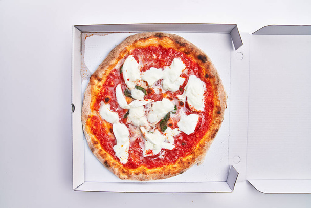  Single margherita italian pizza on delivery box isolated over white background - Photo, Image