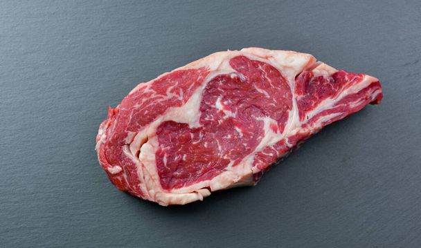 Fresh Black Angus Rib Eye Steak Raw on a dark background. - Foto, Imagen