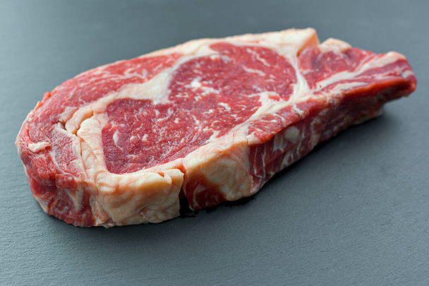Fresh Black Angus Rib Eye Steak Raw on a dark background. - Photo, Image