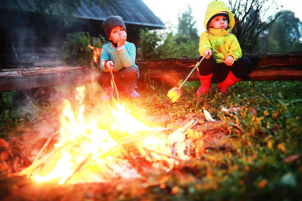 Little children frying marshmallows on bonfire night. Summer cam - 写真・画像