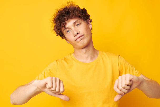 guy with red curly hair wearing stylish yellow t-shirt posing isolated background unaltered - Photo, Image