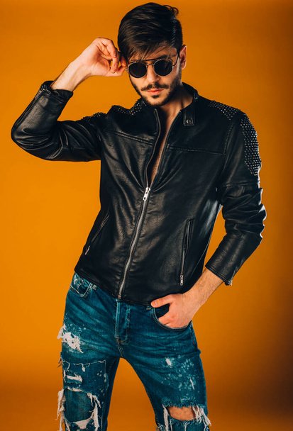 Sexy man wearing ripped pants and modern style leather jacket - Φωτογραφία, εικόνα