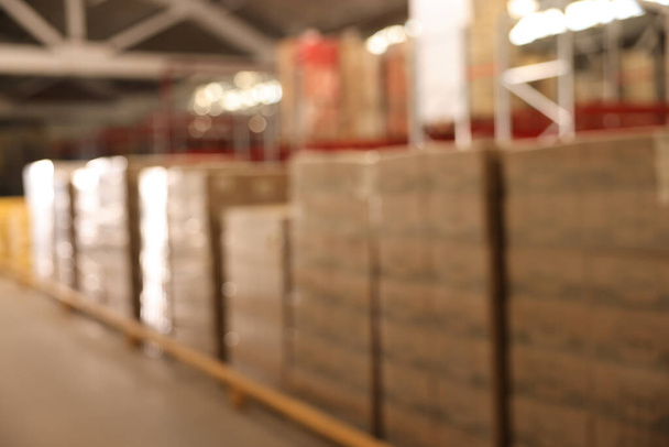 Warehouse with lots of products, blurred view. Wholesale business - Photo, Image