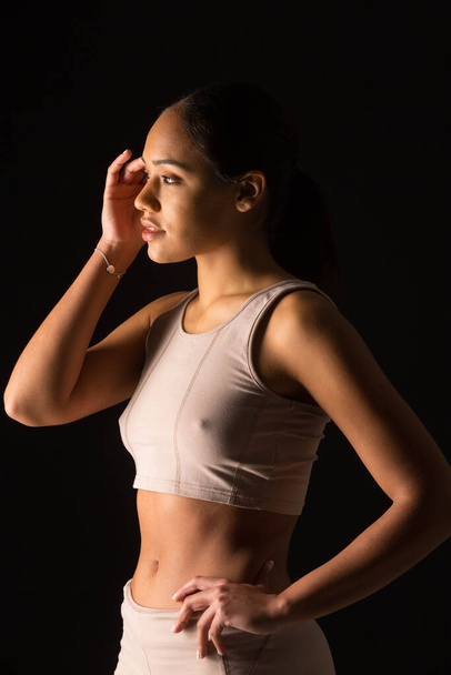 intimate photo of woman in sports clothes on black background - Φωτογραφία, εικόνα