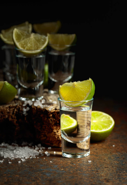Tequila shots with lime and salt on a rusty background.  - Photo, Image