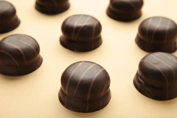 Chocolate sweets on beige background. Top view - Zdjęcie, obraz