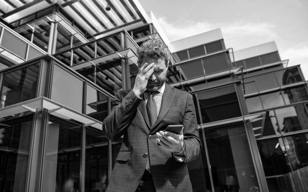 bankruptcy of sad mature business man in formalwear holding phone outdoor, anxiety - Fotoğraf, Görsel