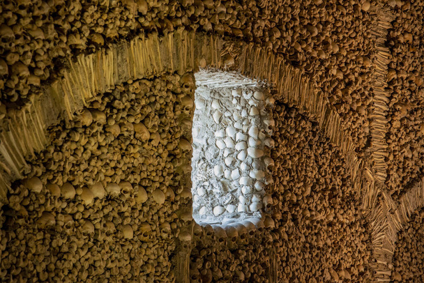 Human Bones at the Capela dos Ossos at the St Francis Church or igreja de Sao Francisco in the old Town of the city Evora in Alentejo in Portugal.  Portugal, Evora, October, 2021 - Photo, Image