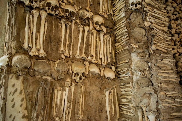Human Bones at the Capela dos Ossos at the St Francis Church or igreja de Sao Francisco in the old Town of the city Evora in Alentejo in Portugal.  Portugal, Evora, October, 2021 - Photo, Image