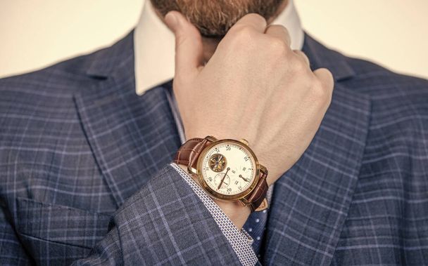 Class is timeless. Wristwatch worn on male arm wrist. Business wristwatch collection. Time management - Фото, изображение