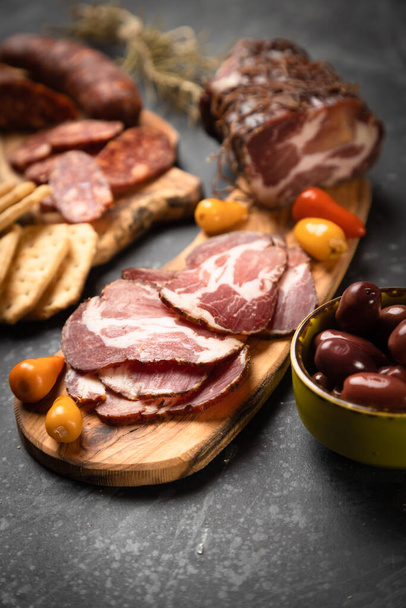 Charcuterie board with various cured meats and sausages - 写真・画像