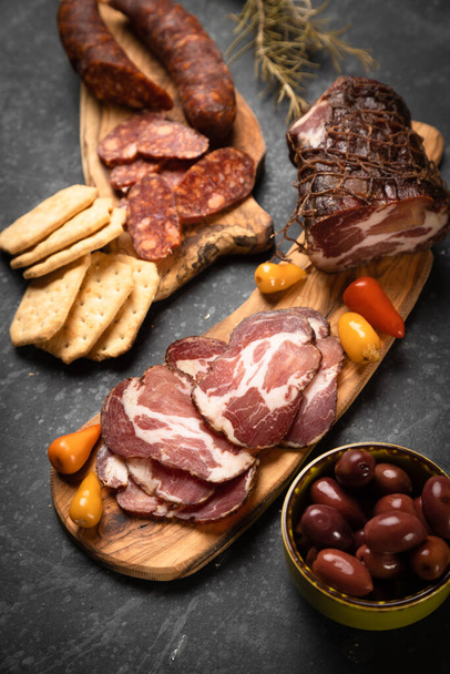Charcuterie board with various cured meats and sausages - Foto, imagen