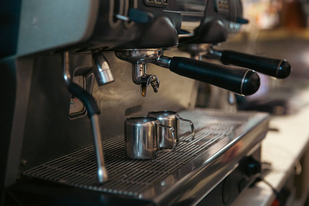 Primer plano del proceso de fabricación de café expreso en una cafetera profesional. - Foto, Imagen