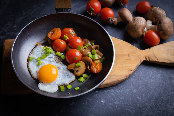Sunny side up fried eggs with mushrooms and cherry tomato - Foto, Imagem