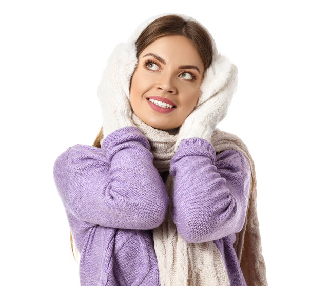 Beautiful young woman in warm winter clothes on white background - Zdjęcie, obraz