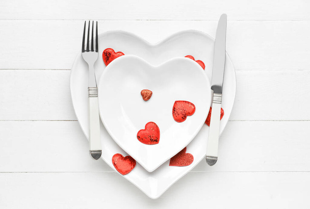 Stylish table setting for Valentine's Day on white wooden background - 写真・画像