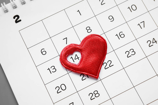 Calendar with heart on grey background, closeup. Valentine's Day celebration - Photo, Image