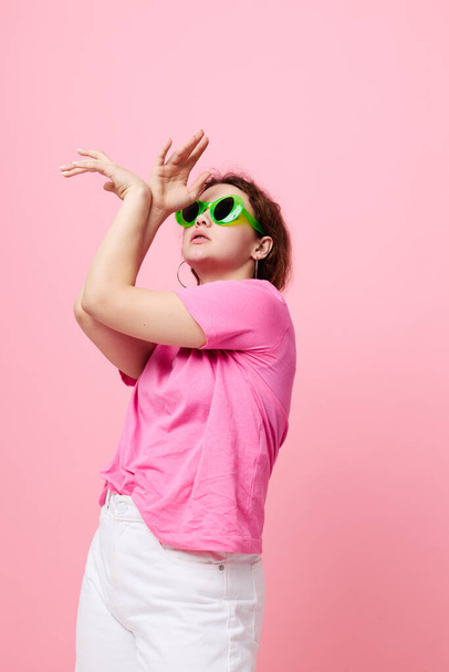 portrait of a young woman in a pink T-shirt green glasses Youth fashion Studio - Fotoğraf, Görsel