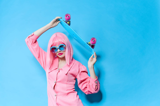 portrait of a woman in sunglasses wears a pink wig studio model unaltered - Foto, imagen