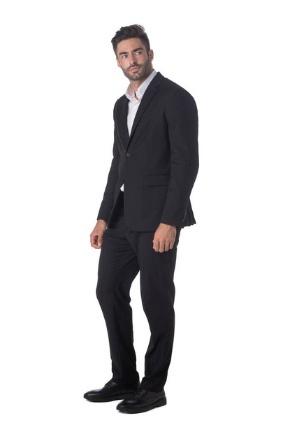 Handsome businessman wearing black suit standing isolated on white studio background - Zdjęcie, obraz