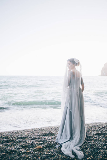 Beautiful woman bride under a veil near the sea. wedding, happiness, lifestyle concept - Φωτογραφία, εικόνα