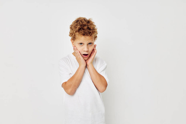 Photo of young boy smile in white t-shirt isolated background - Фото, изображение