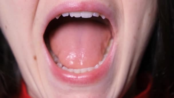 Un paciente con disfunción temporomandibular abre ampliamente la boca, hace clic y desplaza la mandíbula inferior lateralmente - Metraje, vídeo
