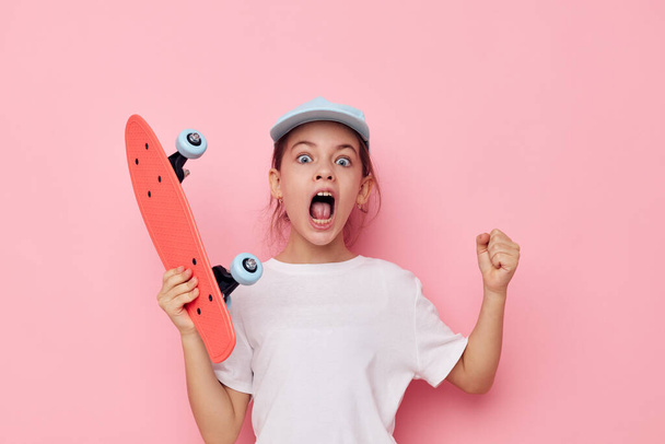 pretty young girl cap in white t-shirt skateboard isolated background - Foto, immagini