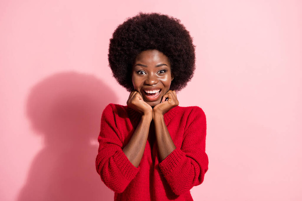 Photo of amazed excited dark skin happy woman hold fists face pretty smile isolated on pastel pink color background - Фото, изображение