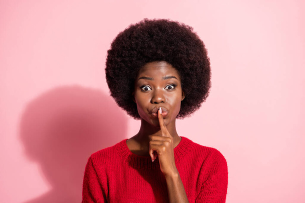 Photo of dark skin lady finger covering mouth lips look camera wear sweater isolated on pink color background - Foto, Imagem
