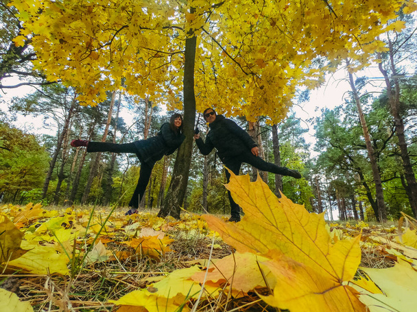 Autumn. Man and woman take a selfie with yellow leaves. - Valokuva, kuva