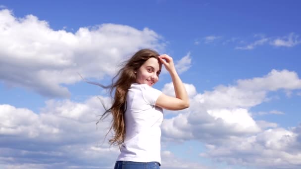 happy child has long beautiful hair enjoy the sun on sky background, childhood - Кадры, видео