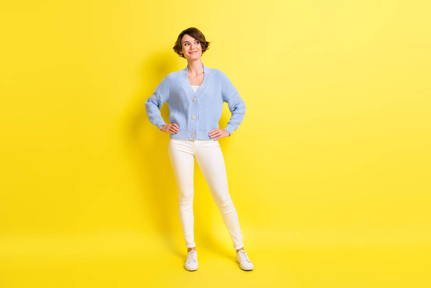 Full body photo of young attractive girl happy positive smile dream look empty space isolated over yellow color background - Valokuva, kuva