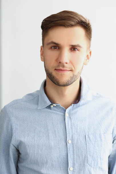 Successful young man in stylish grey shirt, presentable guy posing on white - Foto, Imagem