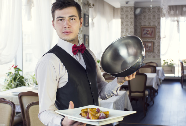 Waiter with a tray of food - Фото, зображення