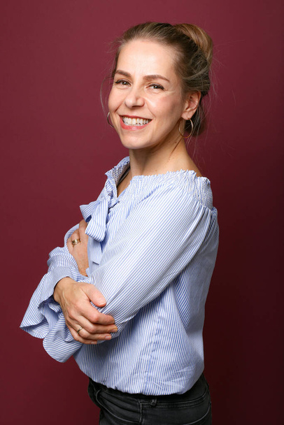 Portrait of a beautiful happy woman in front of a colored background - Photo, image