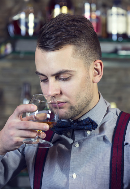 Young man working as a bartender - Fotó, kép