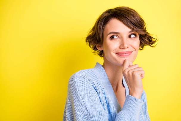 Photo of young attractive girl happy positive smile dream dreamy think look empty space isolated over yellow color background - Фото, зображення